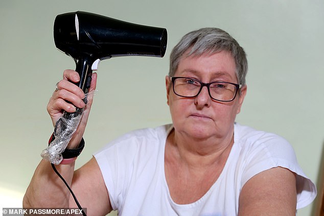 Mrs Knight – pictured holding the clingfilmed handle of her hairdryer – says it upsets her that she can't do normal things which other people do