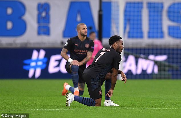 Raheem Sterling (front) and Kyle Walker are seen taking the knee moments before kick-off