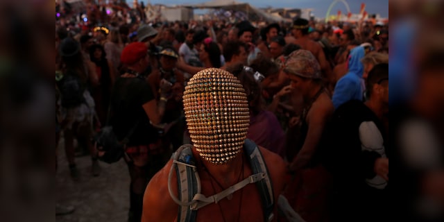 A participant wears a mask as he dances as approximately 70,000 people from all over the world gathered for the annual Burning Man arts and music festival in the Black Rock Desert of Nevada, U.S. August 29, 2017. REUTERS/Jim Urquhart FOR USE WITH BURNING MAN RELATED REPORTING ONLY. FOR EDITORIAL USE ONLY. NOT FOR SALE FOR MARKETING OR ADVERTISING CAMPAIGNS. NO THIRD PARTY SALES. NOT FOR USE BY REUTERS THIRD PARTY DISTRIBUTORS. TPX IMAGES OF THE DAY - RTX3DXG5