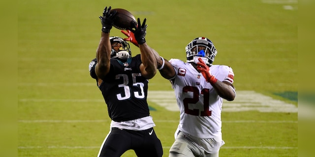 Philadelphia Eagles' Boston Scott, left, catches a touchdown pass against New York Giants' Jabrill Peppers during the second half of an NFL football game, Thursday, Oct. 22, 2020, in Philadelphia. (AP Photo/Derik Hamilton)