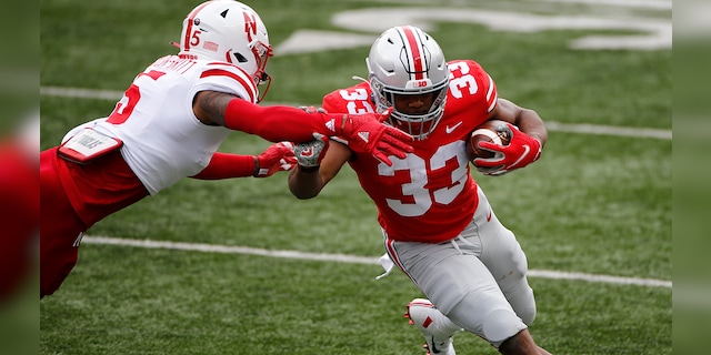 Nebraska defensive back Cam Taylor-Britt, left, forces Ohio State running back Master Teague out of bounds during the first half of an NCAA college football game Saturday, Oct. 24, 2020, in Columbus, Ohio. (AP Photo/Jay LaPrete)