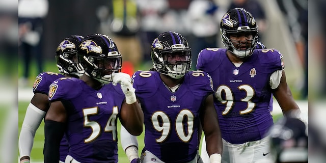 Baltimore Ravens defenders Pernell McPhee (90) Calais Campbell (93) prepare for the next play during an NFL football game against the Houston Texans, Sunday, Sept. 20, 2020, in Houston. (AP Photo/Matt Patterson)