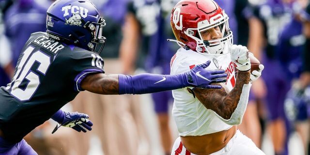 Oklahoma running back Seth McGowan (1) carries the ball as TCU cornerback C.J. Ceasar II (16) defends during the second half of an NCAA college football game, Saturday, Oct. 24, 2020, in Fort Worth, Texas. Oklahoma won 33-14. (AP Photo/Brandon Wade)