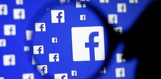 File photo: A man poses with a magnifier in front of a Facebook logo on display in this illustration taken in Sarajevo, Bosnia and Herzegovina, December 16, 2015. REUTERS/Dado Ruvic/Illustration