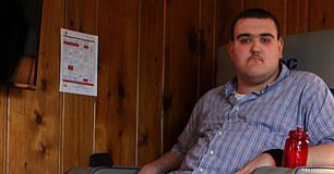 Broc Brown suffers from gigantism and measures an astonishing 7ft 9ins. The 22-year-old is pictured at his home in Michigan on April 20