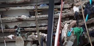 In this April 30, 2013 file photo, a worker toils in a collapsed garment factory building in Savar, near Dhaka, Bangladesh.