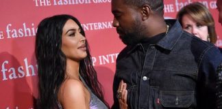 Recording artist Kanye West, right, and wife Kim Kardashian West attend The Fashion Group International