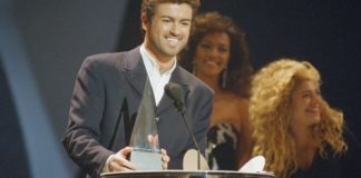 George Michael accepts one of his three American Music Awards during ceremonies in Los Angeles.