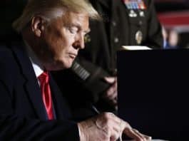President Donald Trump signs the National Defense Authorization Act for Fiscal Year 2020 at Andrews Air Force Base, Md., Friday, Dec. 20, 2019. (AP Photo/Andrew Harnik)