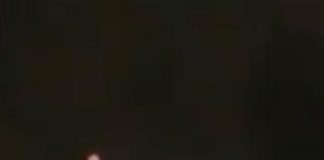 A red orb is seen in the sky before a strange object of equal size appears to emerge from it